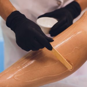 beauty-depilation-epilation-hair-removal-people-concept-beautiful-woman-with-applicator-applying-depilatory-wax-her-leg_152904-5231